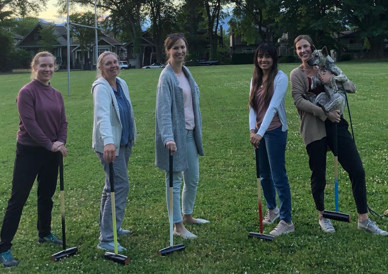 Members of lab playing croquet.